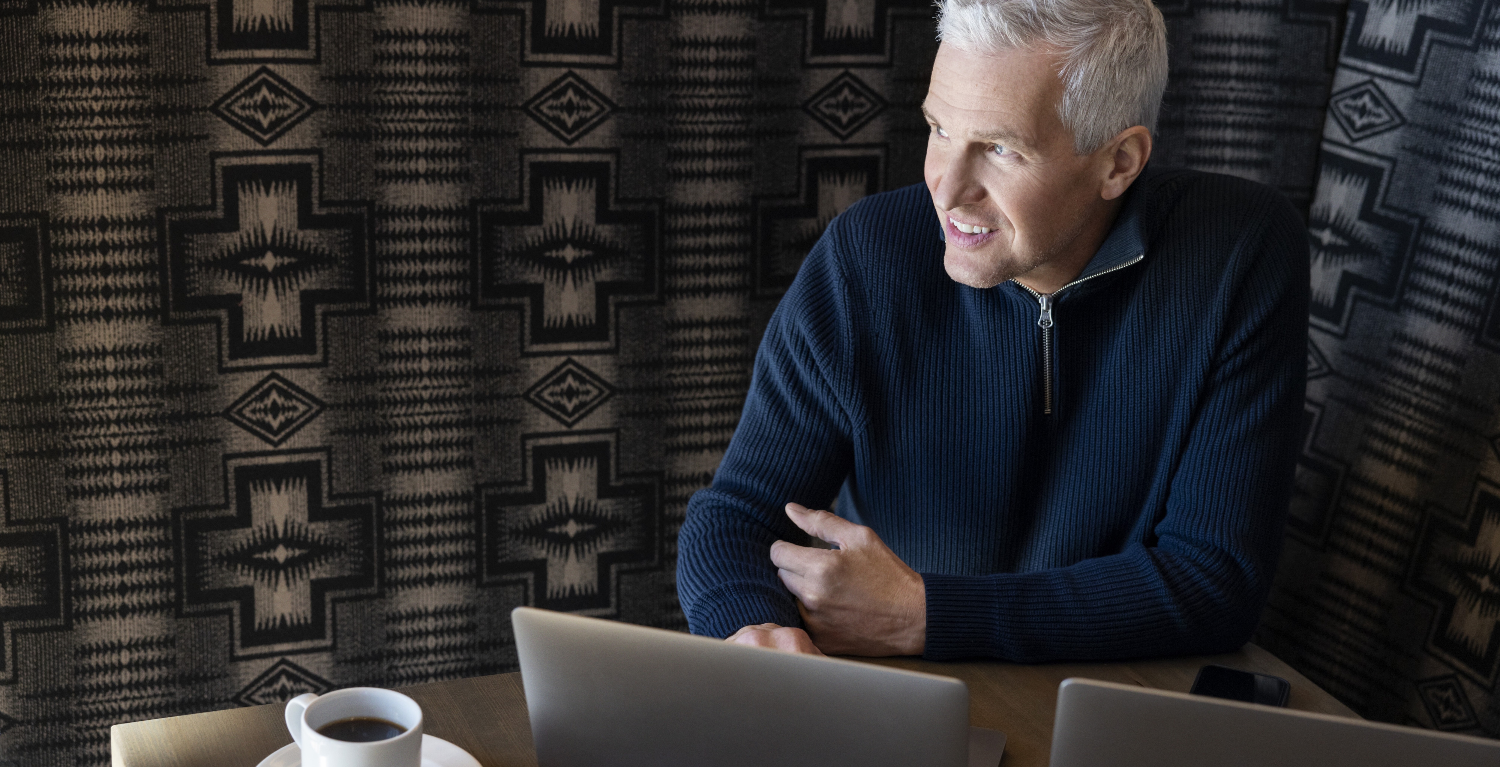 man smiling at a laptop