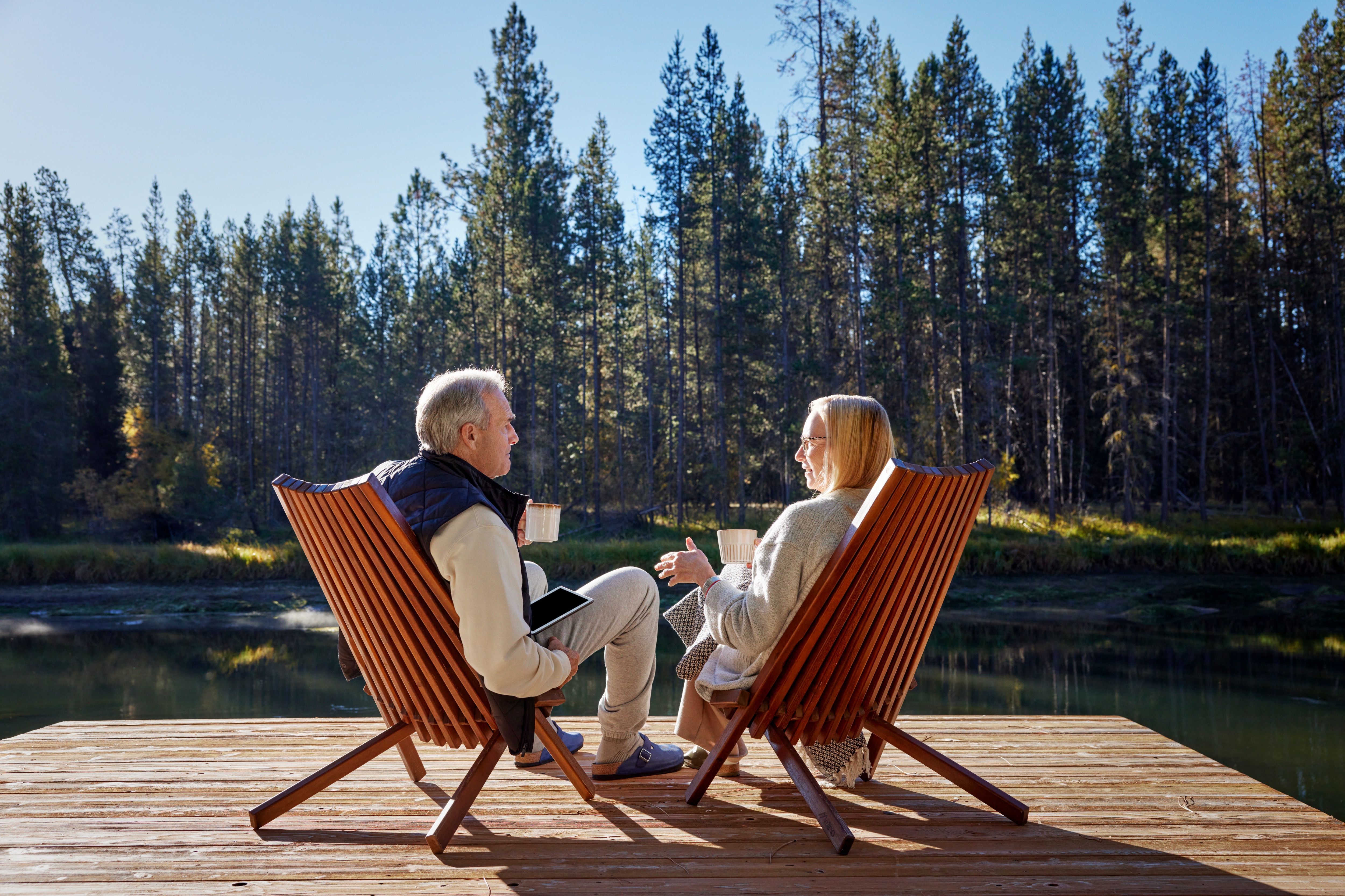 couple sitting by the lake talking