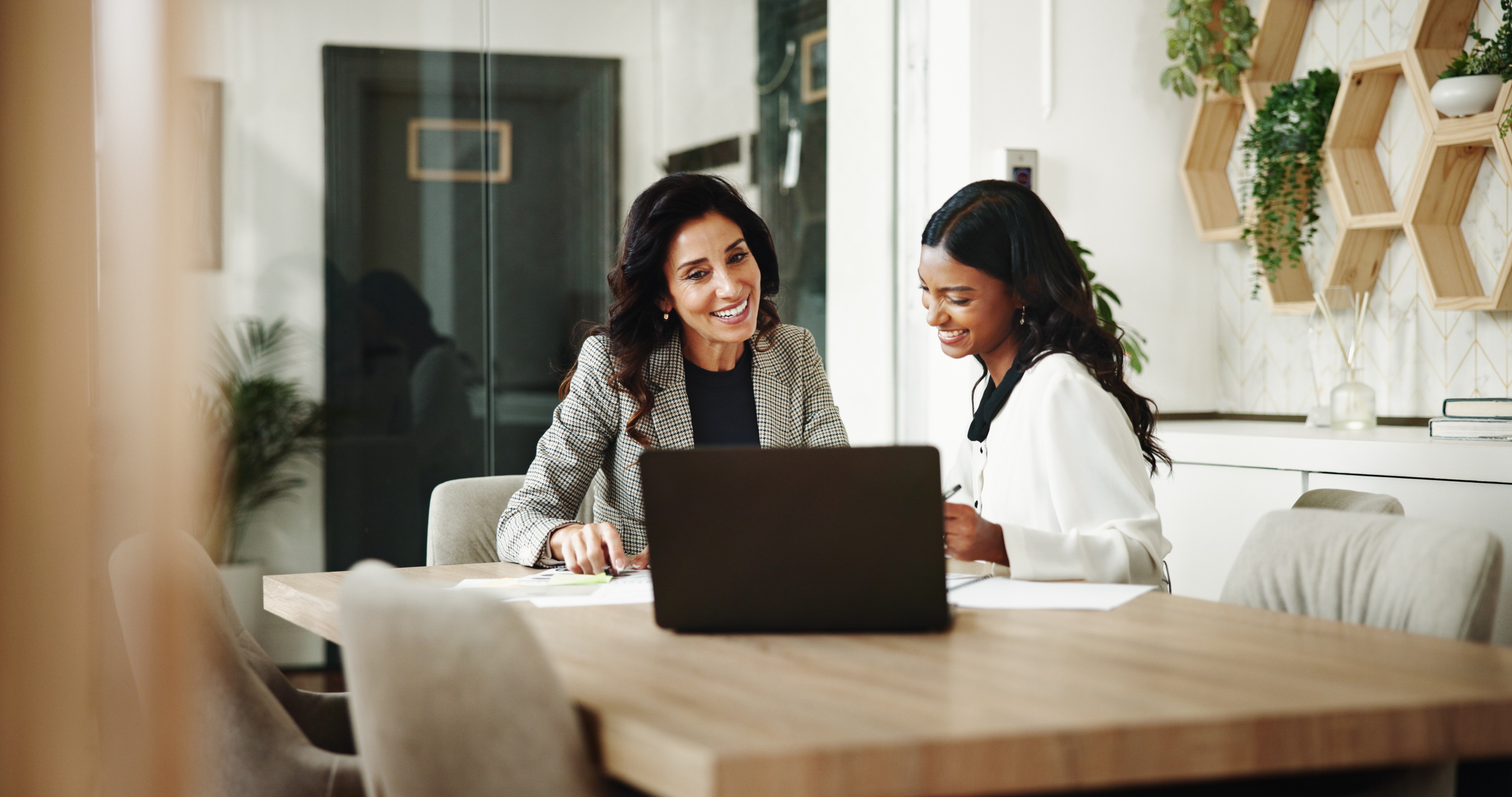 Meeting, women and business people with laptop in office, investment project and discussion. Teamwork, accountant and financial advisor with feedback for finance update, report review and documents.