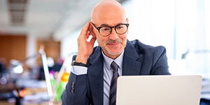 man looking at his laptop