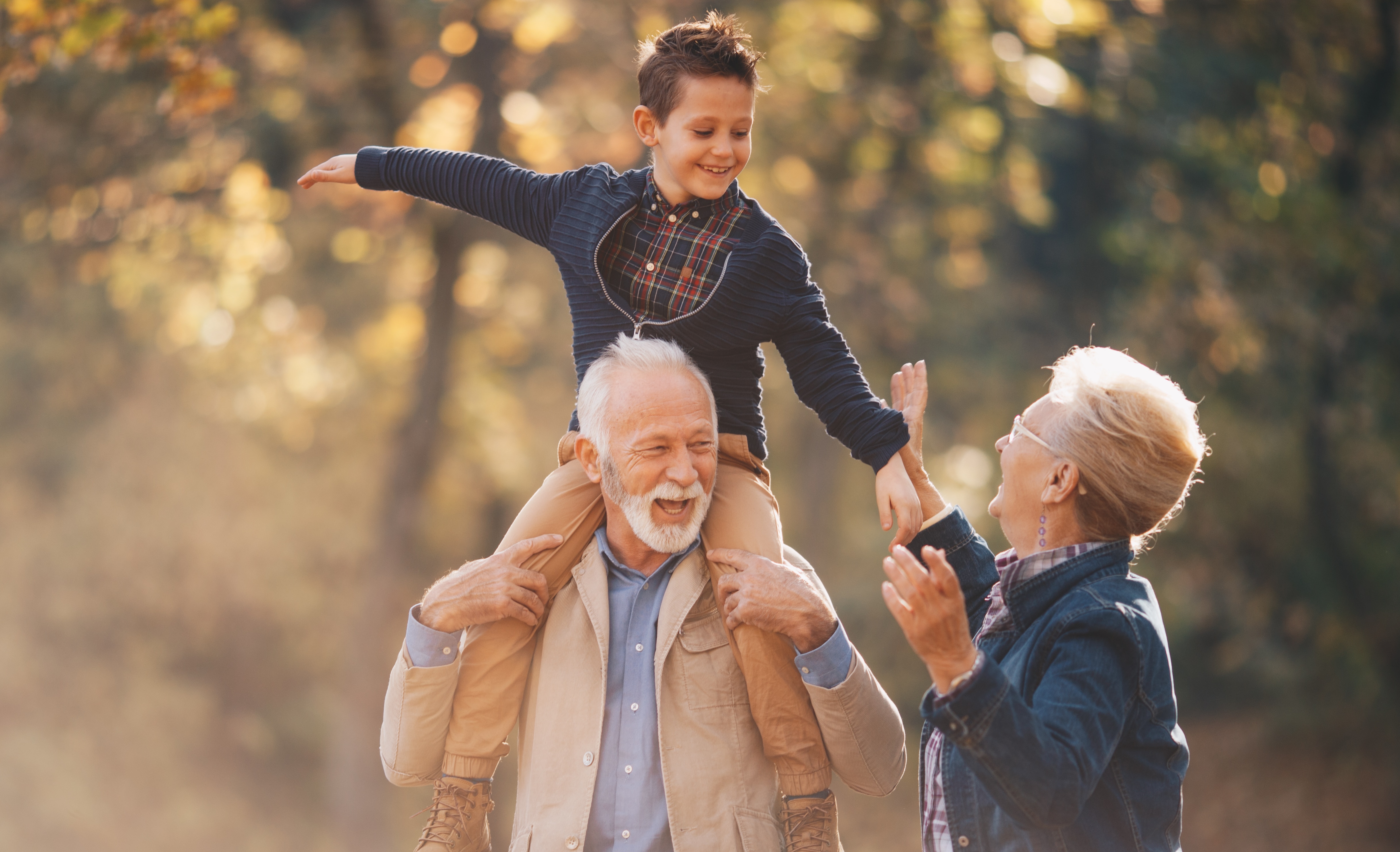 Grandparents with grandchild on shoulders