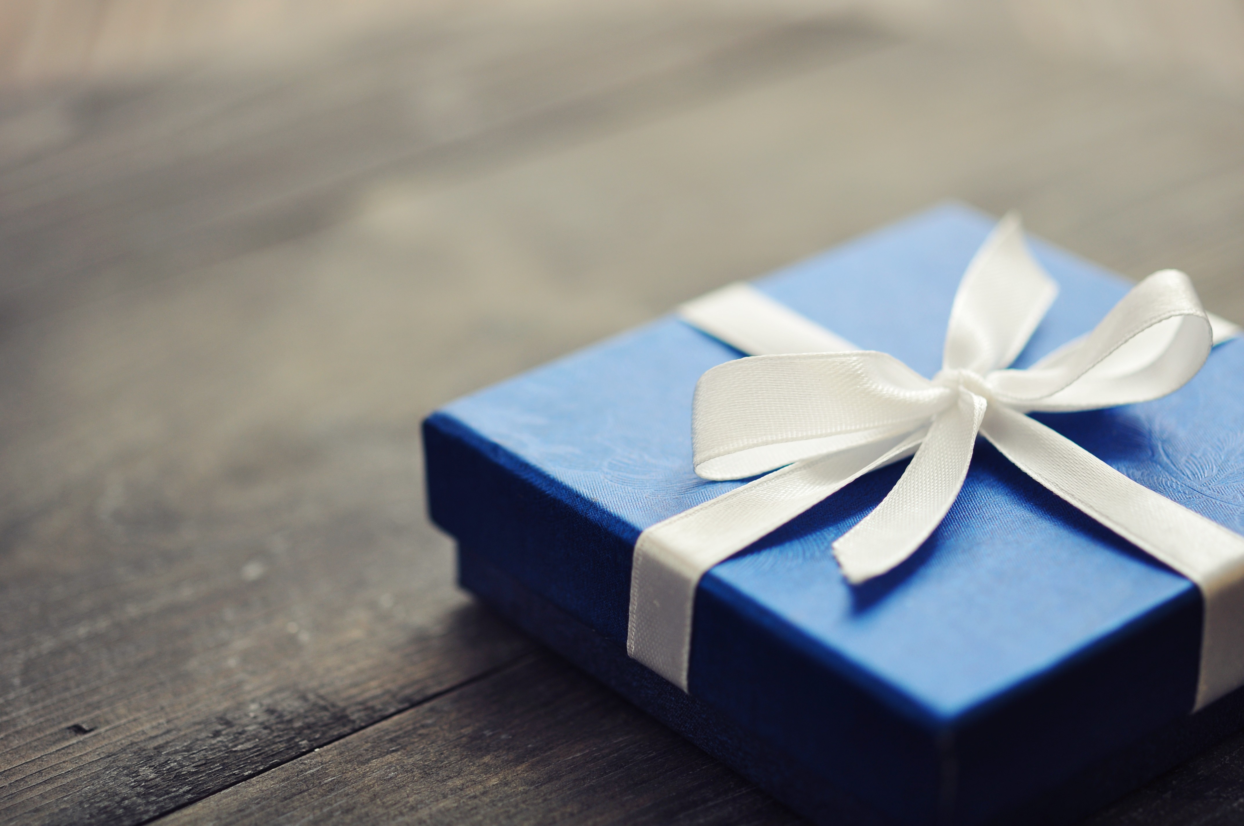Blue elegant gift box on a wooden background