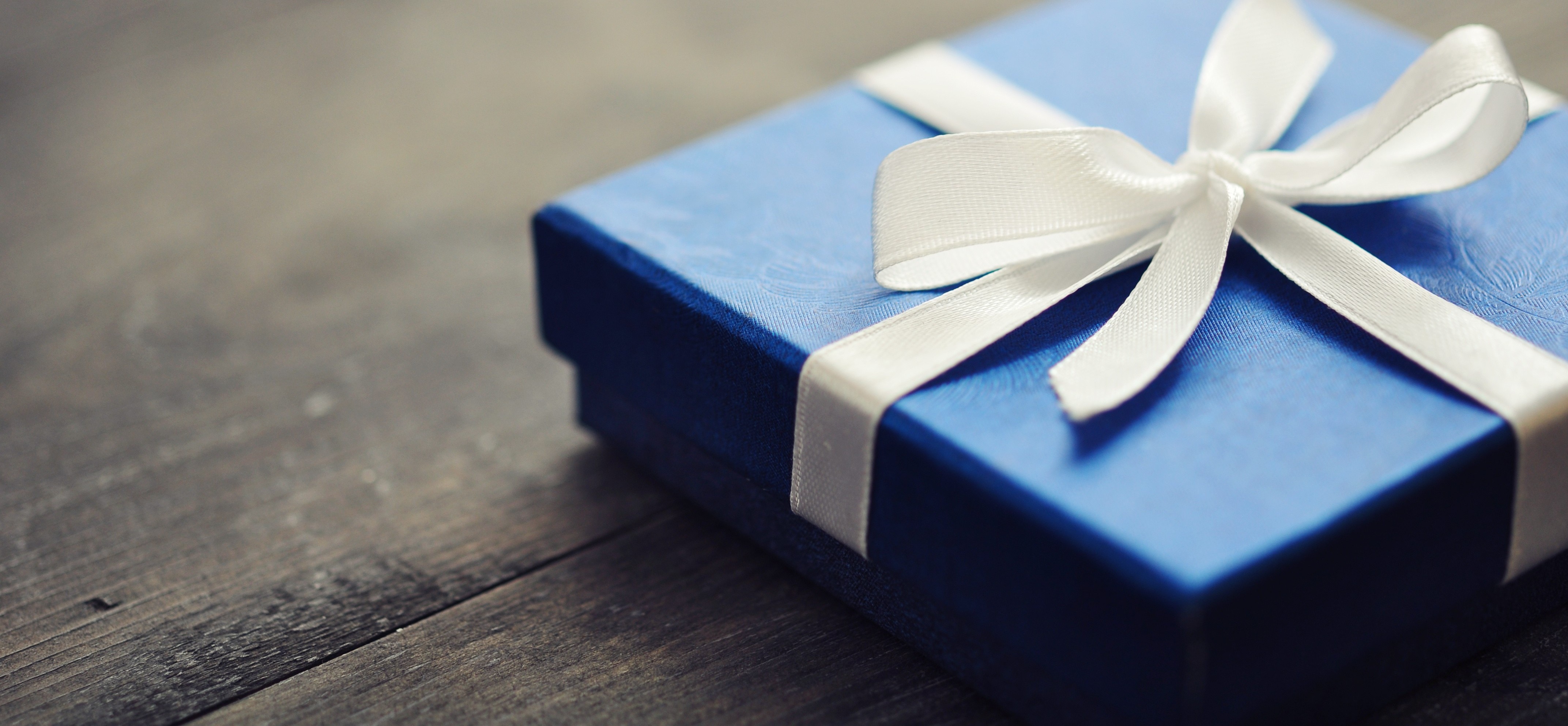 Blue elegant gift box on a wooden background