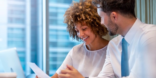 Image of two people reviewing paperwork