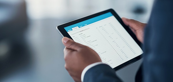 Man holding tablet with data