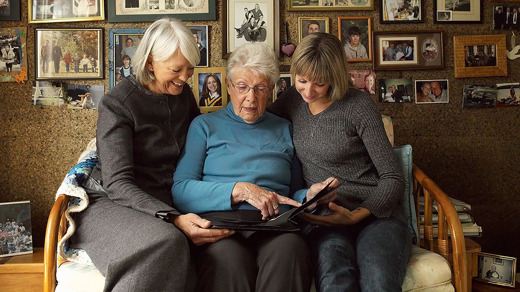 Three Generations of women looking at a photo album