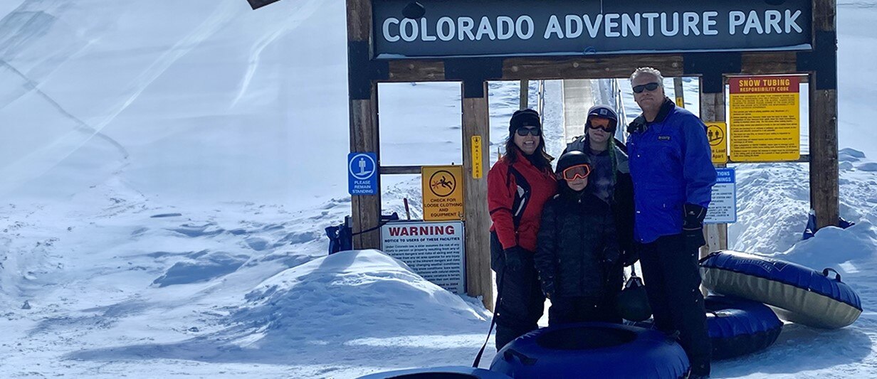 Gina snow tubing with her husband and two children