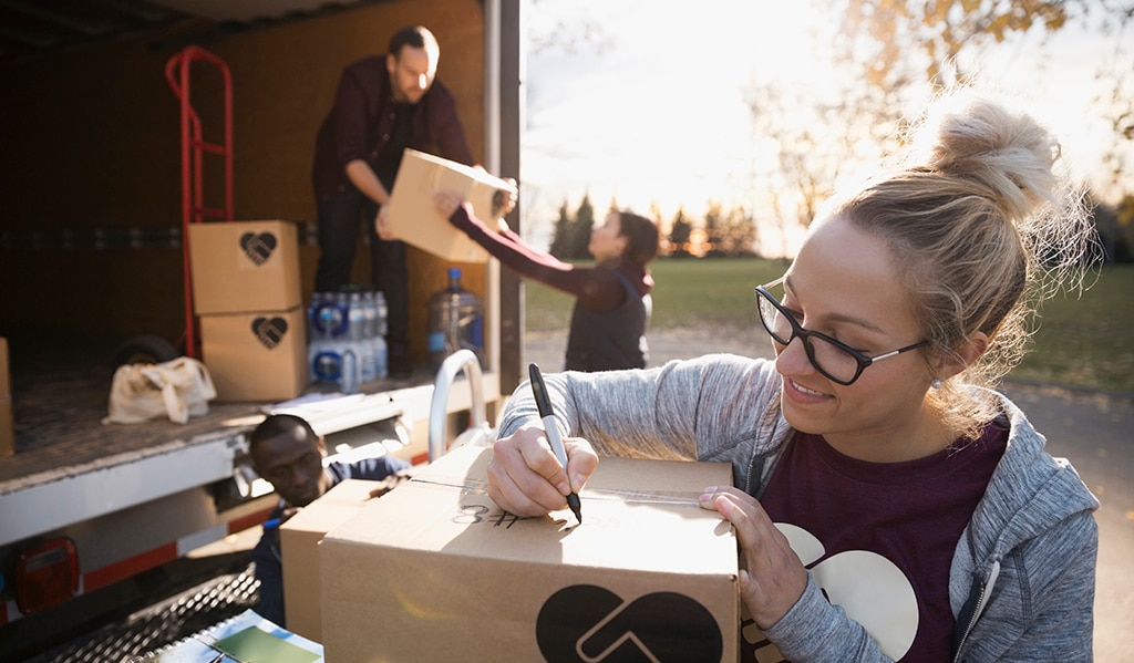 Woman labeling box for donation pickup