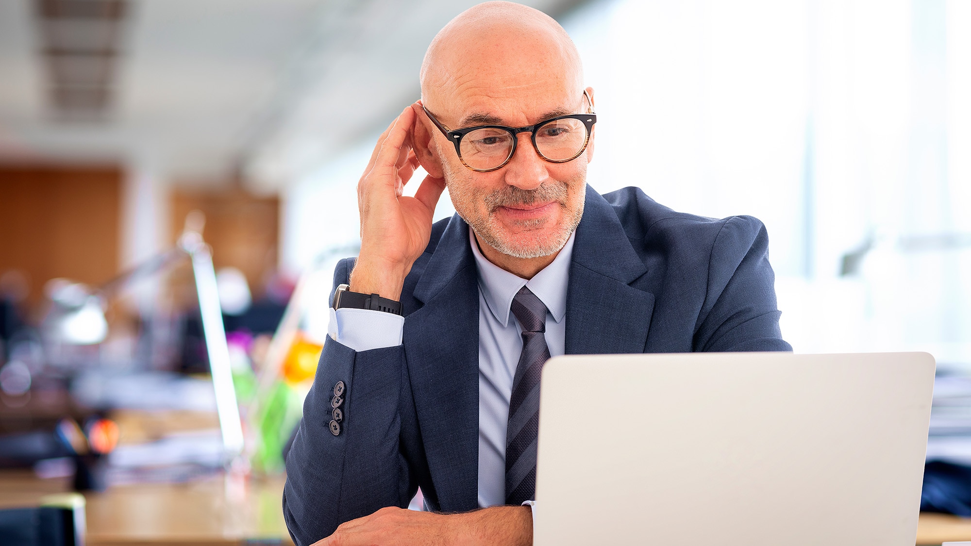 Man at desk looking at computer