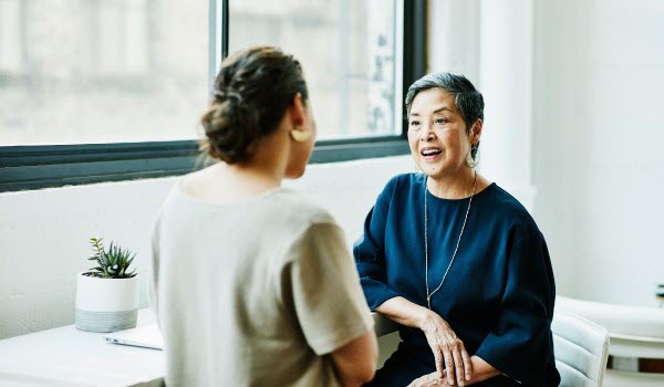 Two women speaking to each other