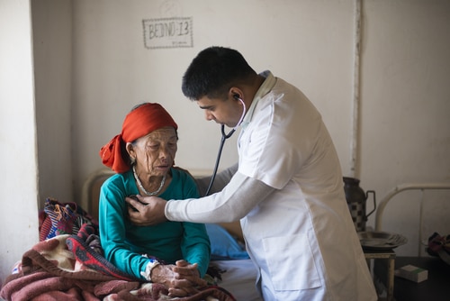 A doctor helping an elderly woman in Nepal