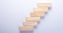 Blocks stacked as a staircase to represent increased benefits