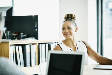 Smiling businesswomen at desk