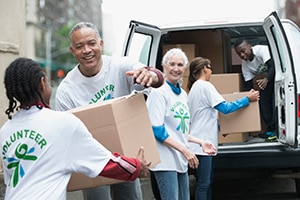 alt=Volunteers loading a truck with supplies